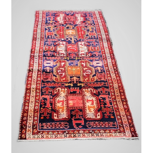 666 - A Iranian runner, with medallion design and animal motif against a blue ground, 293cm x 108cm