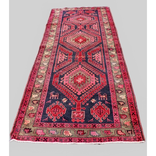 667 - A large North Iranian runner, with cross medallion design in vibrant colours, 324cm x 121cm