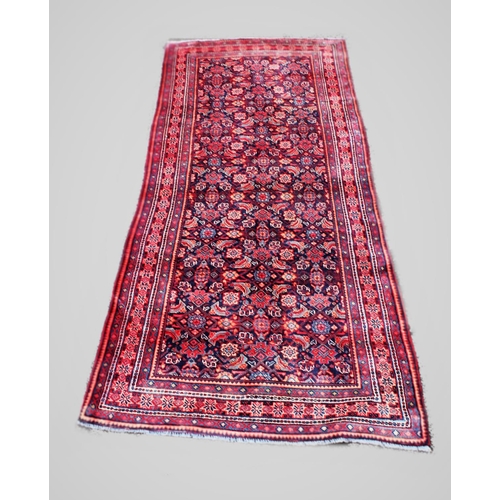 670 - A Persian Saruq runner, with traditional all over design against a blue ground, 279cm x 124cm