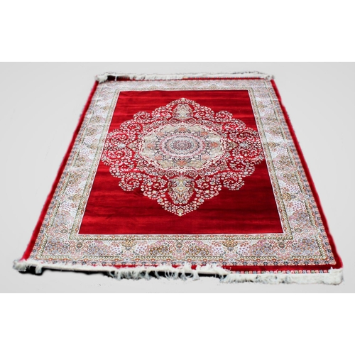 671 - A woven bamboo silk rug, with bespoke floral medallion against a red ground, full pile, 240cm x 160c... 