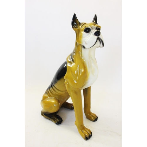 638 - A mid 20th century glazed composite fireside model of a boxer dog, modelled in a seated position wit... 