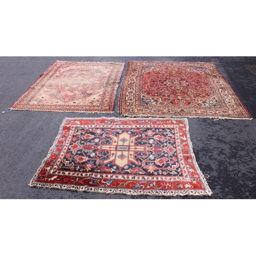 662 - A Caucasian wool rug, the floral design with a central green medallion on a red ground, 205cm x 150c... 