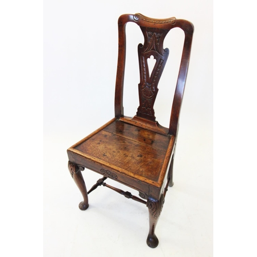 688 - A late 17th century oak side chair, with a pierced and carved vase shaped splat above a board seat w... 