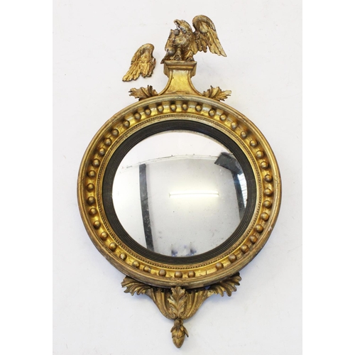 701 - A Regency gilt wood and gesso circular wall mirror, the eagle crest above a 36cm convex mirrored pla... 