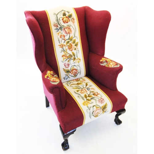 724 - A George III style wing back fireside armchair, late 19th/early 20th century, in burgundy fabric wit... 