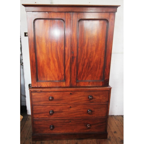 759 - A Victorian mahogany linen press of small proportions, the moulded cornice above two panelled doors ... 