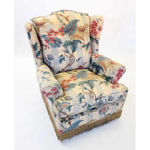 768 - An early 20th century wing back easy chair, covered in striped foliate fabric, the padded wing backs... 