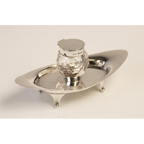 103 - An Edwardian silver and cut glass inkwell and stand by A & J Zimmerman Ltd, Birmingham 1904, the nav... 