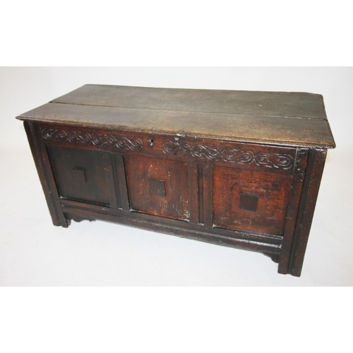 689 - A late 17th/early 18th century oak coffer, the two plank moulded top above a guilloche carved frieze... 