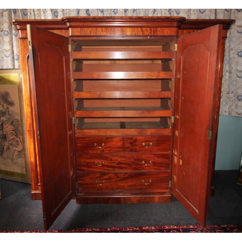 784 - A Victorian mahogany breakfront four door wardrobe, with a cavetto cornice above a pair of central m... 