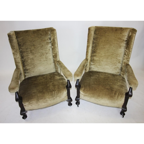 806 - A pair of Edwardian mahogany and upholstered open armchairs, each with a straight back rest, flanked... 