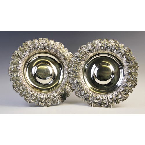 105 - A pair of George IV silver alms dishes by Samuel Hennell, London 1822 (g) and 1823 (h), each of circ... 