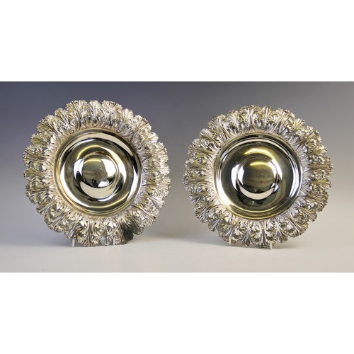 105 - A pair of George IV silver alms dishes by Samuel Hennell, London 1822 (g) and 1823 (h), each of circ... 