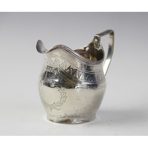 126 - A George III silver cream jug by John Merry, London 1804, of oval baluster form with engraved decora... 