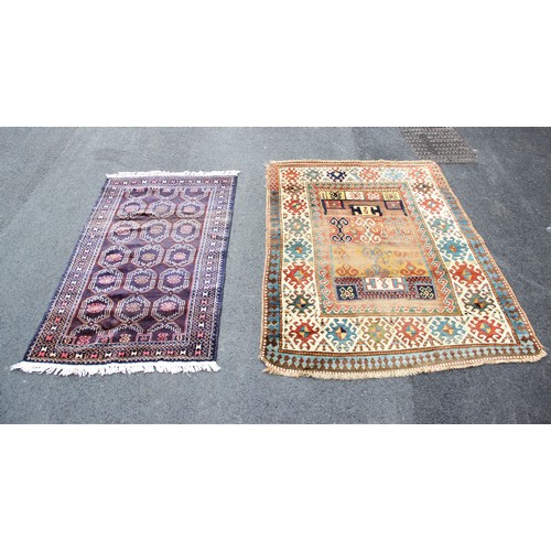 665 - A Bokhara type rug, with repeating octagonal medallions on a claret ground, 158cm x 90cm, along with... 