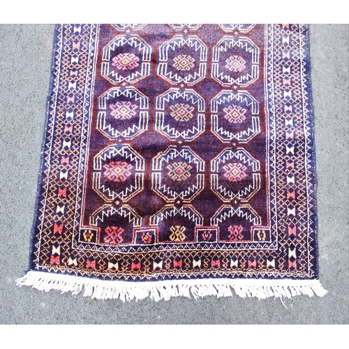 665 - A Bokhara type rug, with repeating octagonal medallions on a claret ground, 158cm x 90cm, along with... 