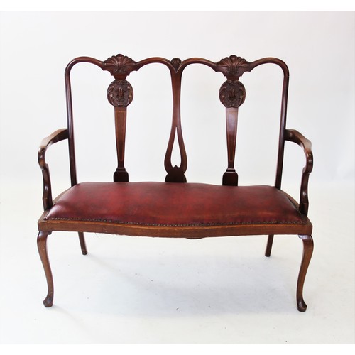 720 - An early 20th century Chippendale revival twin seat mahogany chair, with two carved shell crests abo... 