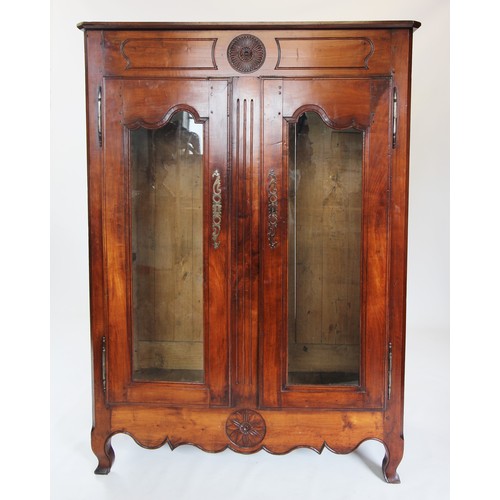 737 - An 18th century and later French cherry wood display cabinet, the frieze centred with a carved flowe... 