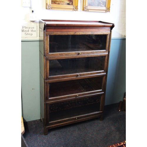 797 - An early 20th century oak Globe Wernicke type stacking bookcase, the over hanging pediment above fou... 