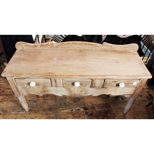 755 - A Victorian pine serving table/dresser, with a shaped raised back above a rectangular slab top and t... 