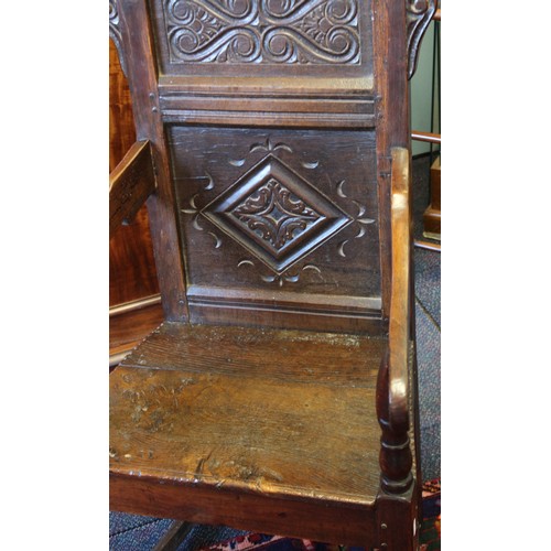 682 - A 17th century and later oak Wainscot chair, the carved pediment with scroll terminals above a panel... 