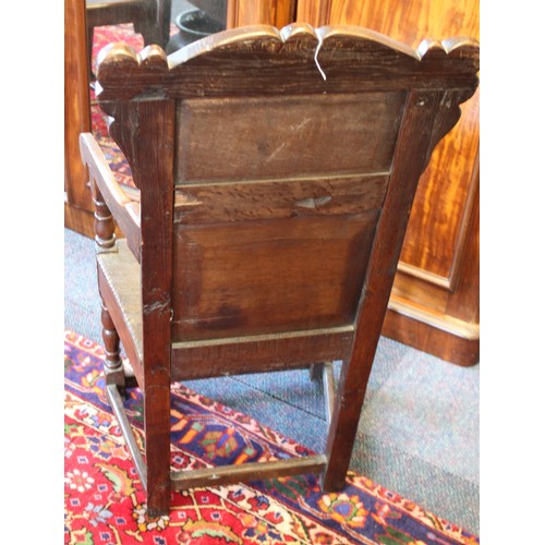 682 - A 17th century and later oak Wainscot chair, the carved pediment with scroll terminals above a panel... 