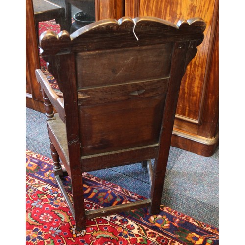 682 - A 17th century and later oak Wainscot chair, the carved pediment with scroll terminals above a panel... 