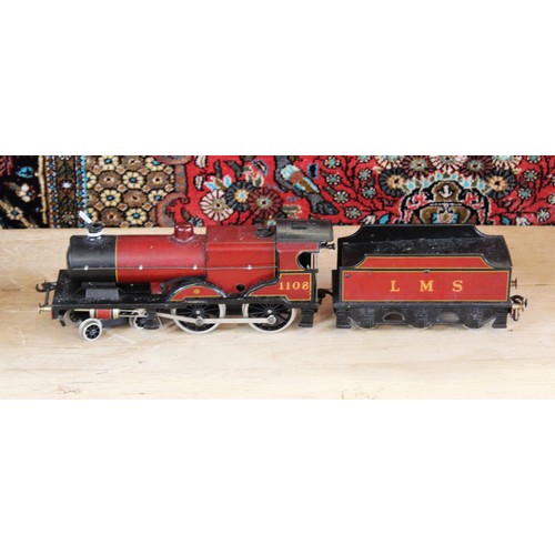 643 - An O Gauge clockwork 4-4-0 locomotive and tender, probably by Bassett-Lowke, in maroon L.M.S. livery... 