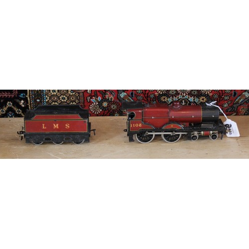 643 - An O Gauge clockwork 4-4-0 locomotive and tender, probably by Bassett-Lowke, in maroon L.M.S. livery... 