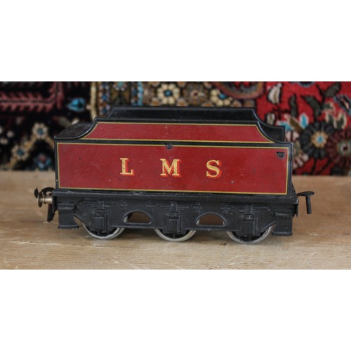 643 - An O Gauge clockwork 4-4-0 locomotive and tender, probably by Bassett-Lowke, in maroon L.M.S. livery... 