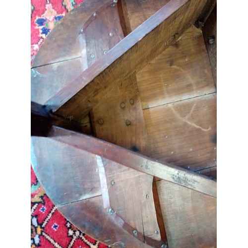 678 - A late 18th century oak cricket table, the circular four plank top top raised upon three chamfered l... 