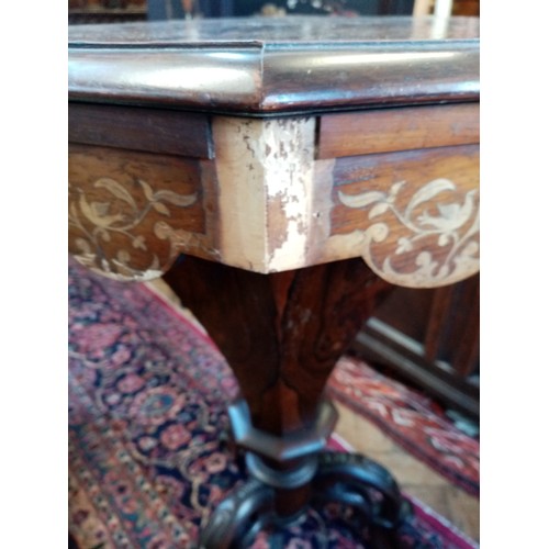 749 - A Victorian inlaid rosewood sewing table, of trumpet form, the octagonal hinged cover enclosing a sa... 