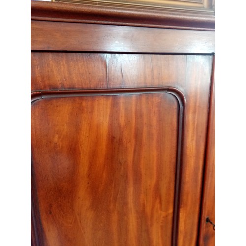 759 - A Victorian mahogany linen press of small proportions, the moulded cornice above two panelled doors ... 