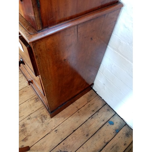 759 - A Victorian mahogany linen press of small proportions, the moulded cornice above two panelled doors ... 