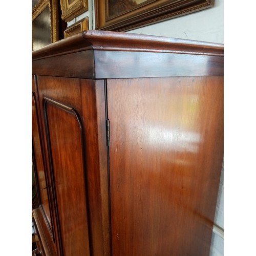 759 - A Victorian mahogany linen press of small proportions, the moulded cornice above two panelled doors ... 