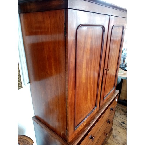 759 - A Victorian mahogany linen press of small proportions, the moulded cornice above two panelled doors ... 