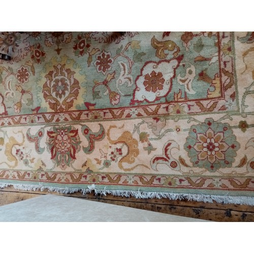 675 - A foliate pattern wool carpet, the central floral medallion surrounded by floral and foliate motifs ... 