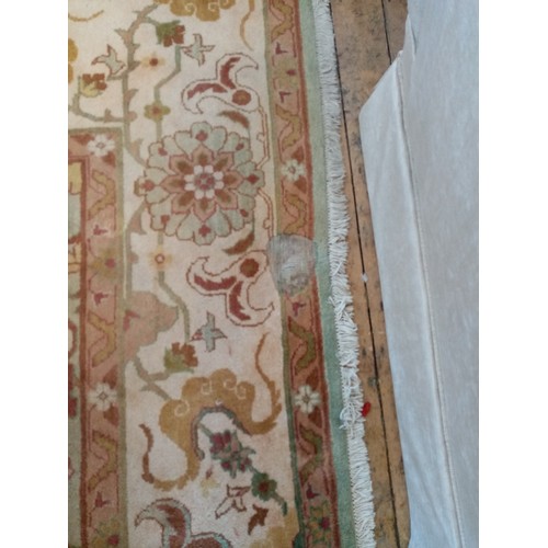 675 - A foliate pattern wool carpet, the central floral medallion surrounded by floral and foliate motifs ... 