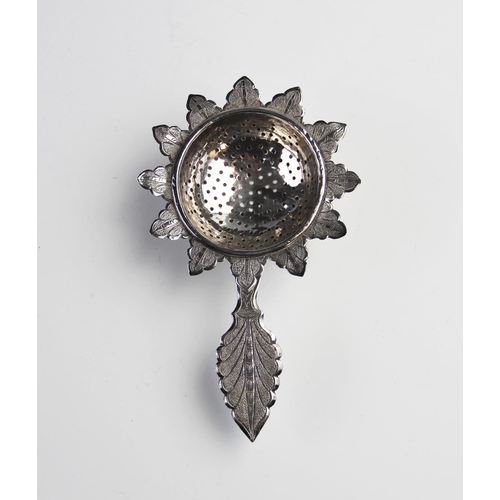 103 - A middle eastern white metal tea strainer and stand, the strainer with with pierced circular bowl, p... 