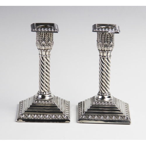 104 - A pair of Victorian silver weighted desk candlesticks by Jacob Berman, London, one dated 1888, the o... 