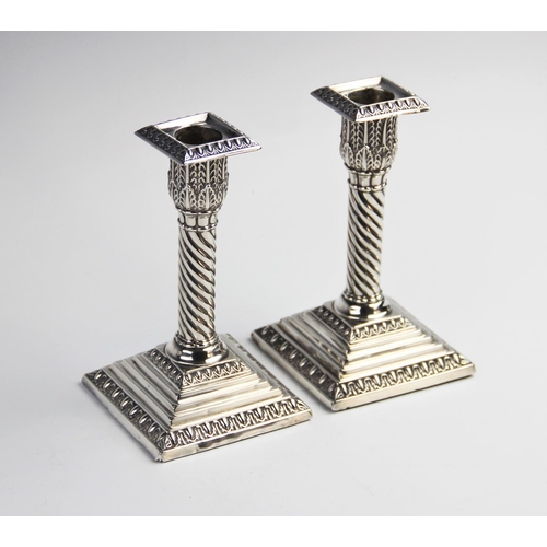 104 - A pair of Victorian silver weighted desk candlesticks by Jacob Berman, London, one dated 1888, the o... 