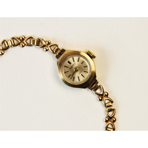 114 - A lady's 9ct vintage 'Kered' wristwatch, the circular silver dial with baton markers, set to a plain... 