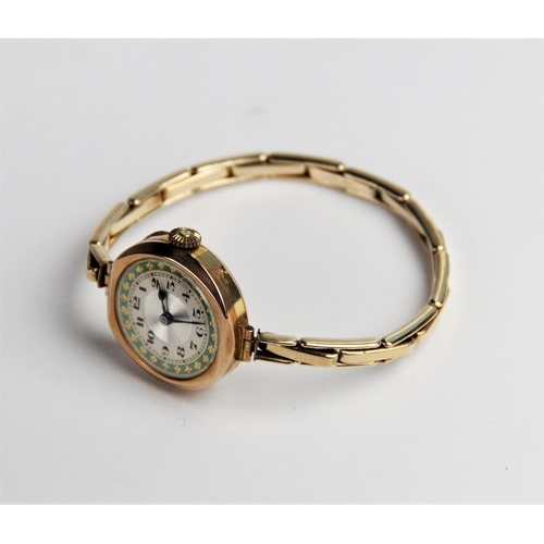 124 - A vintage 9ct gold lady's wristwatch, the round silvered dial with engine turned decoration and Arab... 