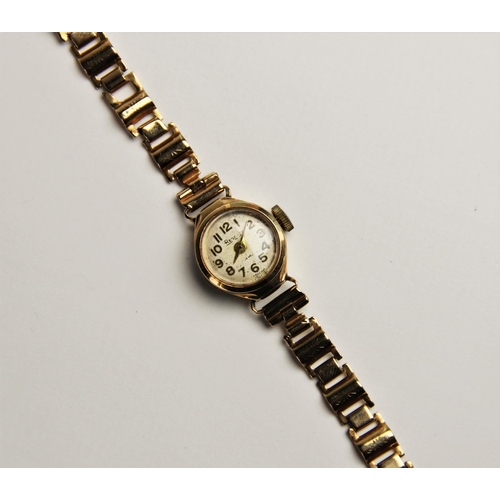 125 - A vintage lady's 9ct Regency wristwatch, the round cream with with Arabic numerals, set to a round p... 