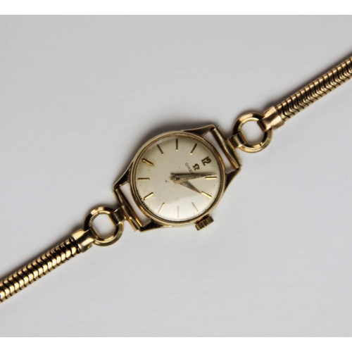 140 - A lady's vintage Omega 9ct gold wristwatch, the round cream dial with baton markers set to a plain p... 