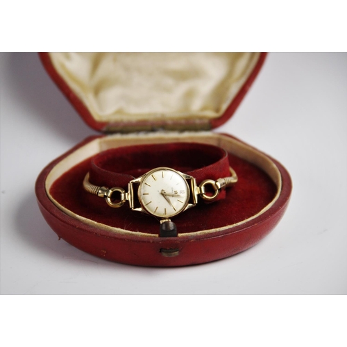 140 - A lady's vintage Omega 9ct gold wristwatch, the round cream dial with baton markers set to a plain p... 