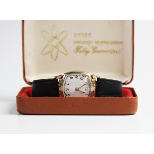 146 - A vintage wristwatch, the white enamel dial with gold toned Arabic numerals and outer seconds track,... 