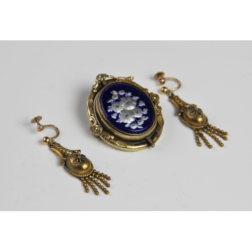 176 - A pair of late Victorian drop earrings, each of tapering form with a floral decoration oval panel te... 