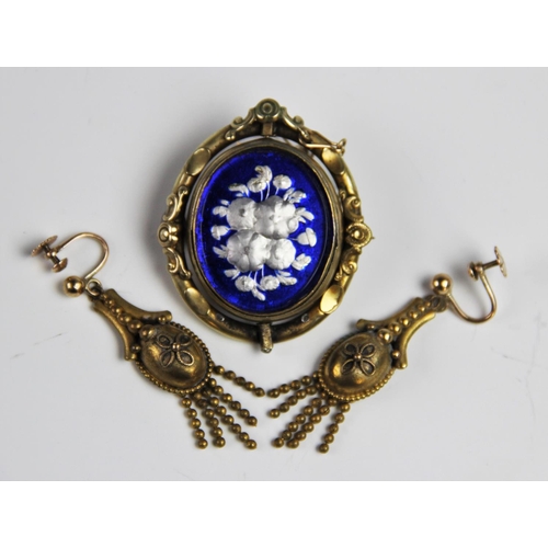 176 - A pair of late Victorian drop earrings, each of tapering form with a floral decoration oval panel te... 