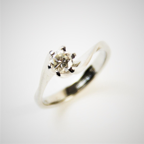 180 - A diamond solitaire ring, comprising a central round brilliant cut diamond weighing an estimated 0.2... 